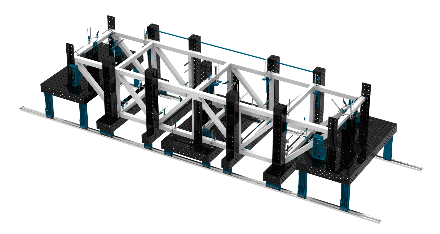 Przestrzenna konstrukcja ułożona na podporach i stołach spawalniczych zamontowanych na systemie szyn SLIDE SYSTEM